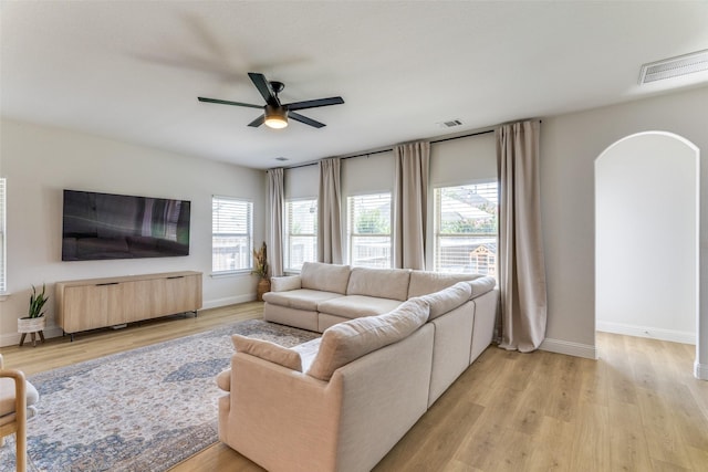 9825 Chaparral Pass, Fort Worth, TX 76126 - living area featuring arched walkways, a ceiling fan, and baseboards