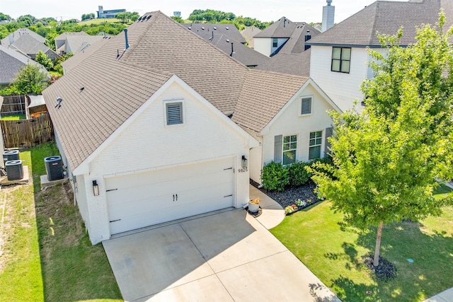 9825 Chaparral Pass, Fort Worth, TX 76126 - view of front of house featuring brick siding, central AC unit, and a shingled roof