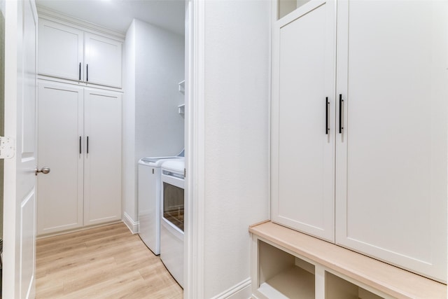 9825 Chaparral Pass, Fort Worth, TX 76126 - laundry area with washer and dryer, light wood-style flooring, and cabinet space