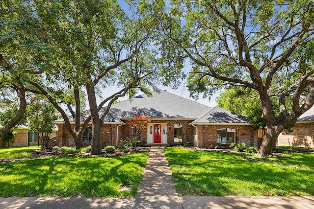 4130 High Star Ln, Dallas, TX 75287 - view of front facade with a front yard, brick siding, and a shingled roof
