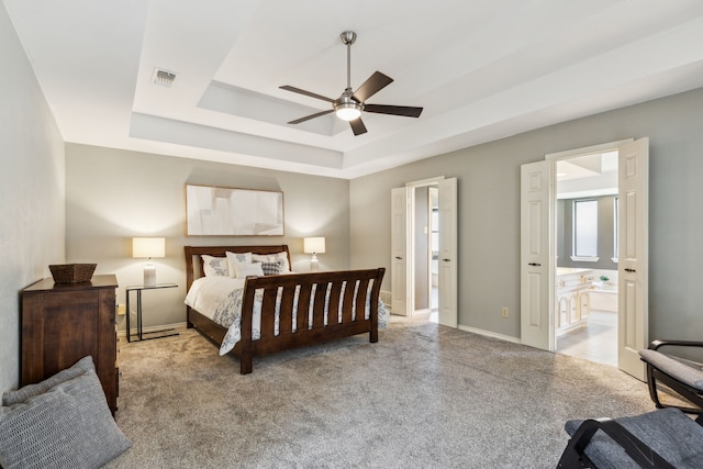 4130 High Star Ln, Dallas, TX 75287 - carpeted bedroom featuring a tray ceiling, baseboards, connected bathroom, and ceiling fan