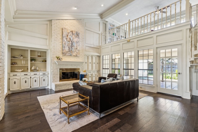 4130 High Star Ln, Dallas, TX 75287 - living area with a fireplace, crown molding, dark wood-type flooring, high vaulted ceiling, and built in features