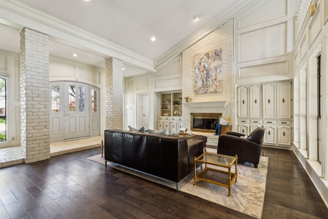 4130 High Star Ln, Dallas, TX 75287 - living area with ornate columns, crown molding, lofted ceiling, dark wood finished floors, and a fireplace