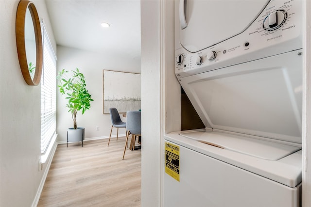 2702 Douglas Ave Unit 128, Dallas, TX 75219 - laundry area featuring stacked washing machine and dryer, light wood finished floors, baseboards, and recessed lighting