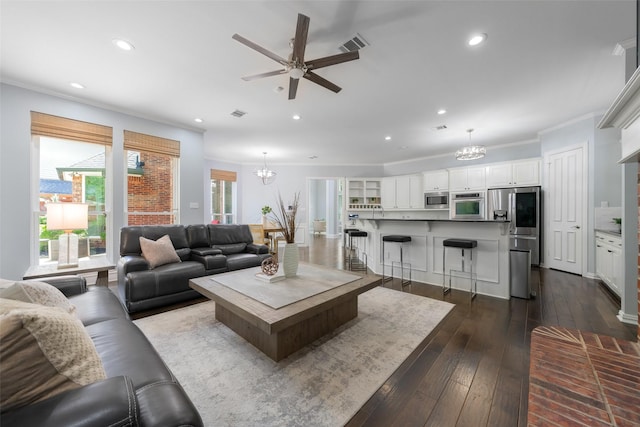 5617 Lindsey Dr, Plano, TX 75093 - living area featuring a chandelier, dark wood-style floors, a ceiling fan, recessed lighting, and crown molding