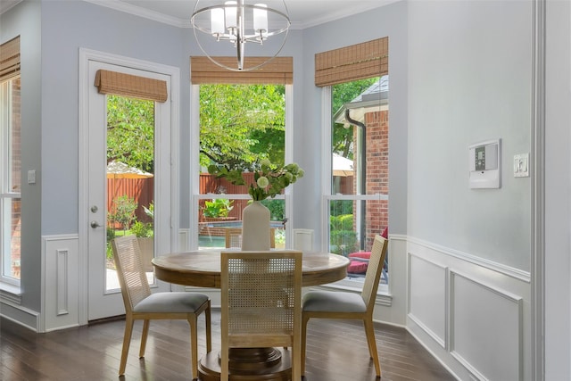 5617 Lindsey Dr, Plano, TX 75093 - dining area featuring a chandelier, dark wood-style flooring, a decorative wall, ornamental molding, and a wainscoted wall