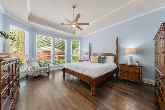 5617 Lindsey Dr, Plano, TX 75093 - bedroom featuring a raised ceiling, crown molding, dark wood-type flooring, multiple windows, and baseboards