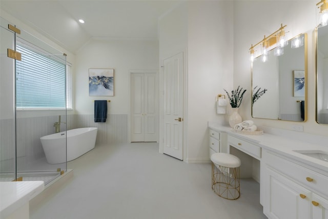 5617 Lindsey Dr, Plano, TX 75093 - bathroom featuring a freestanding tub, wainscoting, vanity, and vaulted ceiling