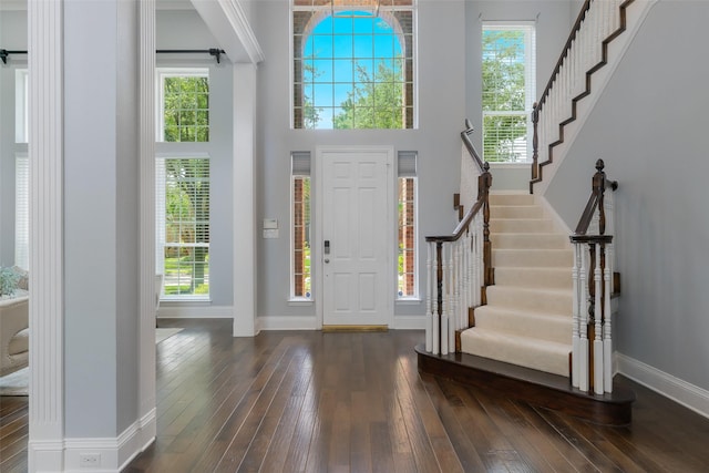 5617 Lindsey Dr, Plano, TX 75093 - entryway with dark wood-style flooring, baseboards, stairs, and a high ceiling