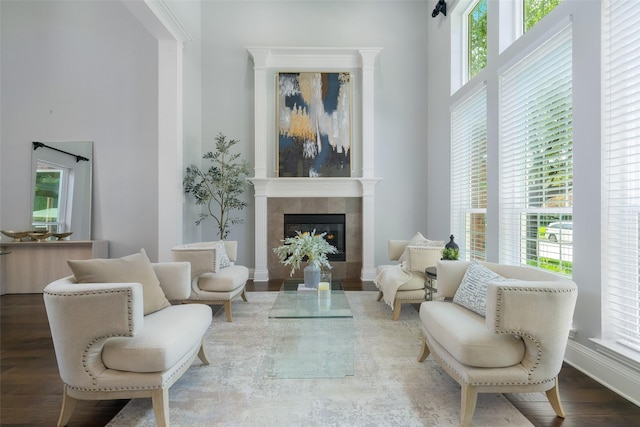 5617 Lindsey Dr, Plano, TX 75093 - sitting room with a tile fireplace, a high ceiling, and wood finished floors