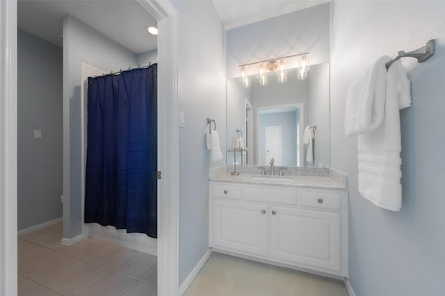 5617 Lindsey Dr, Plano, TX 75093 - bathroom featuring vanity, tile patterned flooring, curtained shower, and baseboards