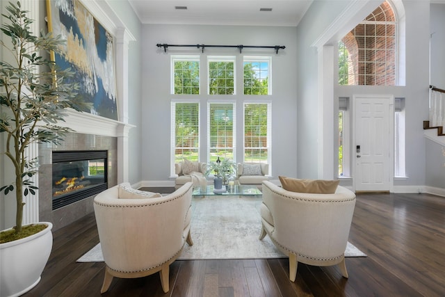 5617 Lindsey Dr, Plano, TX 75093 - living room featuring a tile fireplace, dark wood-type flooring, baseboards, crown molding, and stairway