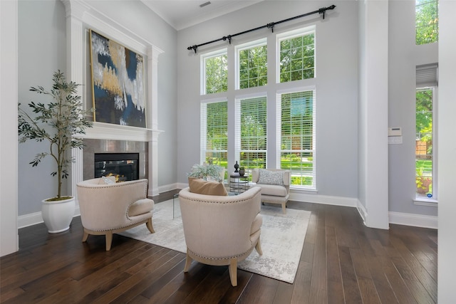 5617 Lindsey Dr, Plano, TX 75093 - living area with baseboards, dark wood-style floors, a tile fireplace, and ornamental molding