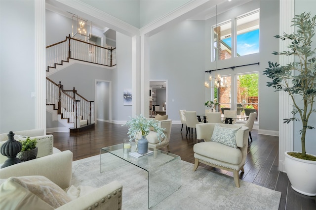 5617 Lindsey Dr, Plano, TX 75093 - living area with a chandelier, stairway, a towering ceiling, wood finished floors, and baseboards