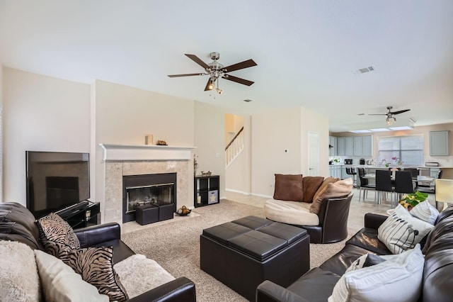631 Ridgemont Dr, Allen, TX 75002 - living room featuring ceiling fan, stairs, a fireplace, and baseboards