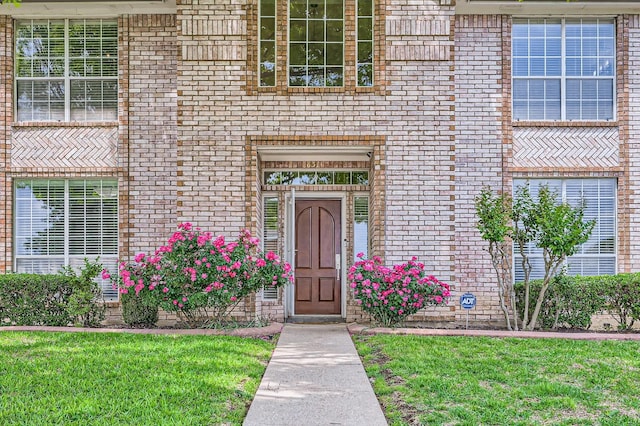 631 Ridgemont Dr, Allen, TX 75002 - view of exterior entry with brick siding and a lawn