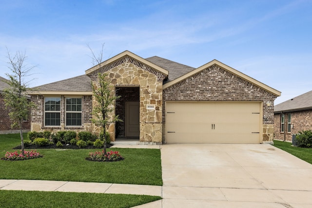 2335 French St, Fate, TX 75189 - view of front of house featuring a garage, a front yard, stone siding, driveway, and brick siding
