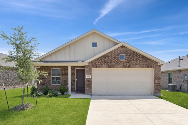 1713 Claireborne Ct, Little Elm, TX 75068 - view of front facade with board and batten siding, brick siding, an attached garage, concrete driveway, and a front yard
