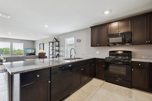 1713 Claireborne Ct, Little Elm, TX 75068 - kitchen featuring black appliances, a sink, a peninsula, plenty of natural light, and recessed lighting