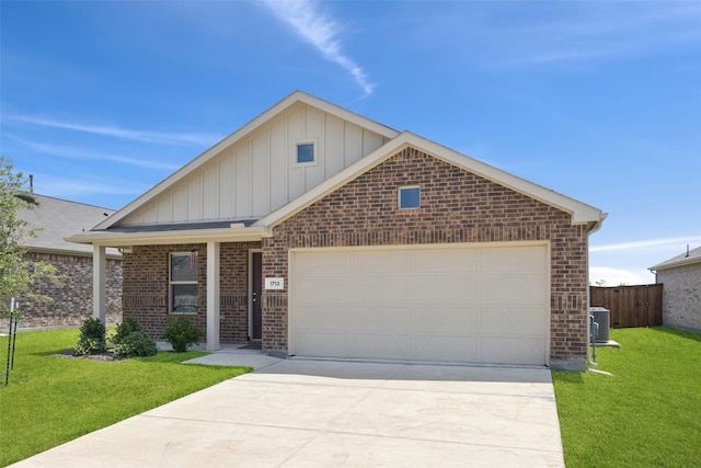 1713 Claireborne Ct, Little Elm, TX 75068 - view of front of home featuring central air condition unit, board and batten siding, driveway, brick siding, and an attached garage