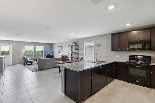 1713 Claireborne Ct, Little Elm, TX 75068 - kitchen featuring black appliances, a sink, a peninsula, recessed lighting, and open floor plan