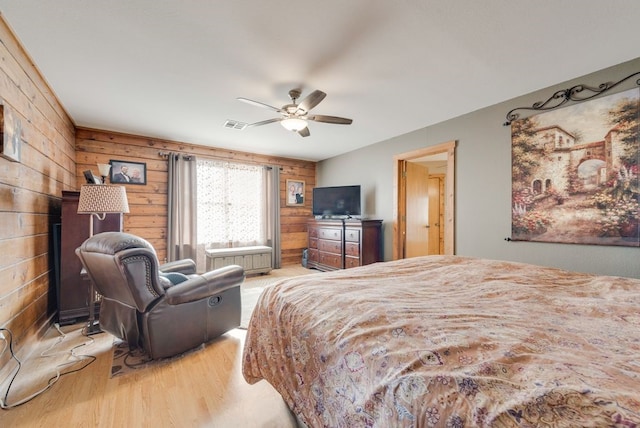 14213 Clark Dr, Streetman, TX 75859 - bedroom featuring light wood-style flooring, wooden walls, and ceiling fan