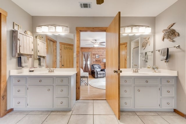 14213 Clark Dr, Streetman, TX 75859 - full bath featuring two vanities, a ceiling fan, tile patterned flooring, wooden walls, and connected bathroom