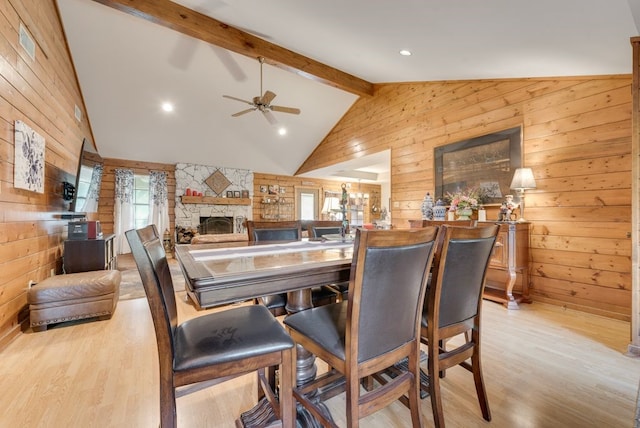 14213 Clark Dr, Streetman, TX 75859 - dining space with wood walls, wood finished floors, a stone fireplace, a ceiling fan, and recessed lighting