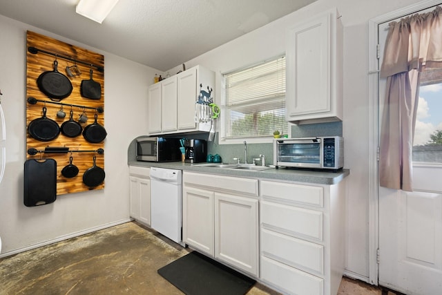 1105 Ashwood Ct, Cleburne, TX 76033 - kitchen featuring dishwasher, stainless steel microwave, unfinished concrete floors, white cabinets, and a sink