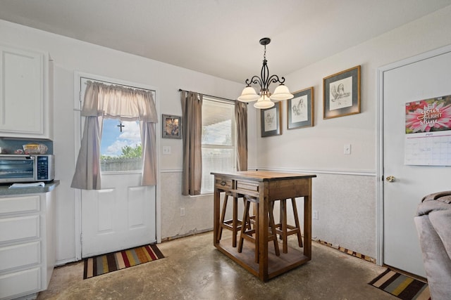 1105 Ashwood Ct, Cleburne, TX 76033 - dining room featuring finished concrete floors and a chandelier