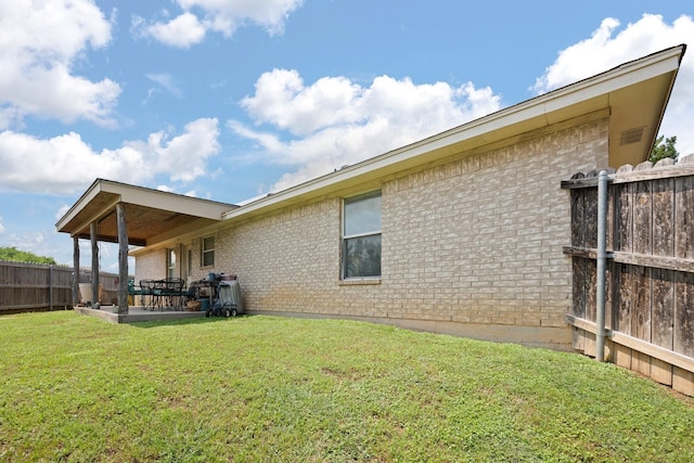 1105 Ashwood Ct, Cleburne, TX 76033 - back of property with brick siding and a patio area