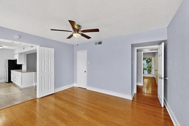 7736 Meadow Rd Unit 203, Dallas, TX 75230 - unfurnished living room featuring ceiling fan and light wood-type flooring