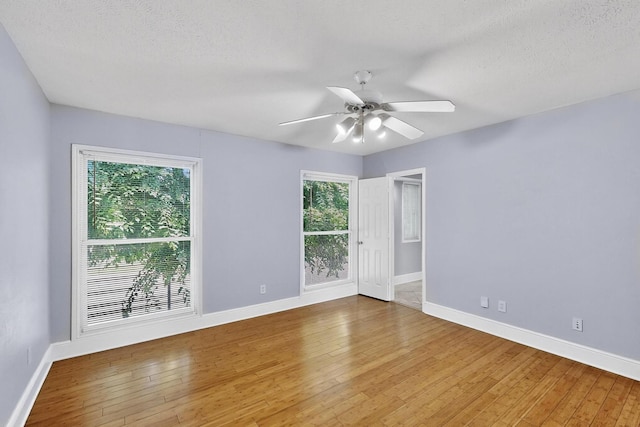7736 Meadow Rd Unit 203, Dallas, TX 75230 - unfurnished room with hardwood / wood-style floors, a ceiling fan, and a textured ceiling