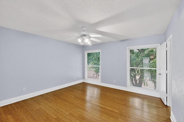 7736 Meadow Rd Unit 203, Dallas, TX 75230 - empty room with a ceiling fan, wood-type flooring, and a textured ceiling
