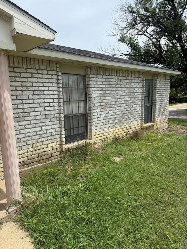 6933 Glenhurst Dr, North Richland Hills, TX 76182 - view of side of home featuring brick siding and a yard
