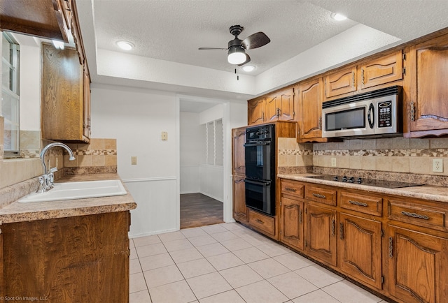 809 Monique, Cedar Hill, TX 75104 - kitchen featuring black appliances, a sink, a textured ceiling, ceiling fan, and light tile patterned floors