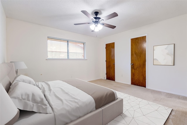 809 Monique, Cedar Hill, TX 75104 - bedroom featuring light carpet, ceiling fan, and multiple closets