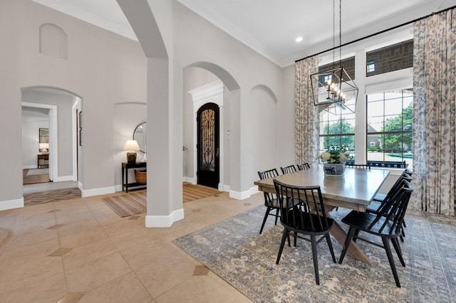 4340 Powers Branch Dr, Midlothian, TX 76065 - dining area with a towering ceiling, a chandelier, tile patterned flooring, arched walkways, and recessed lighting
