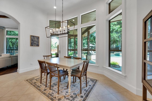 4340 Powers Branch Dr, Midlothian, TX 76065 - dining room with arched walkways, light tile patterned floors, and plenty of natural light