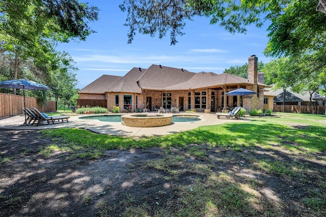4340 Powers Branch Dr, Midlothian, TX 76065 - back of house featuring a patio, a chimney, brick siding, a pool with connected hot tub, and a shingled roof