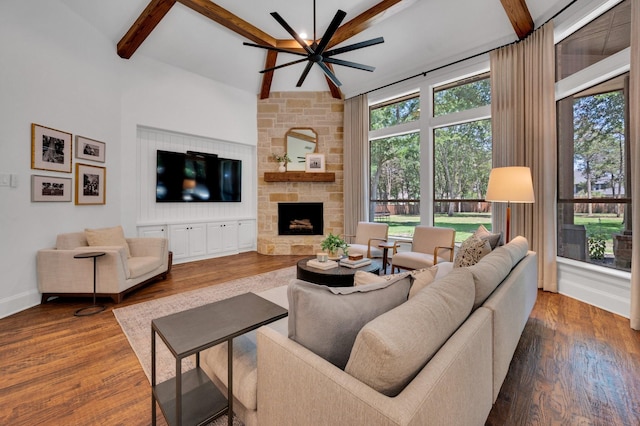 4340 Powers Branch Dr, Midlothian, TX 76065 - living room featuring a ceiling fan, beamed ceiling, a stone fireplace, wood finished floors, and a high ceiling