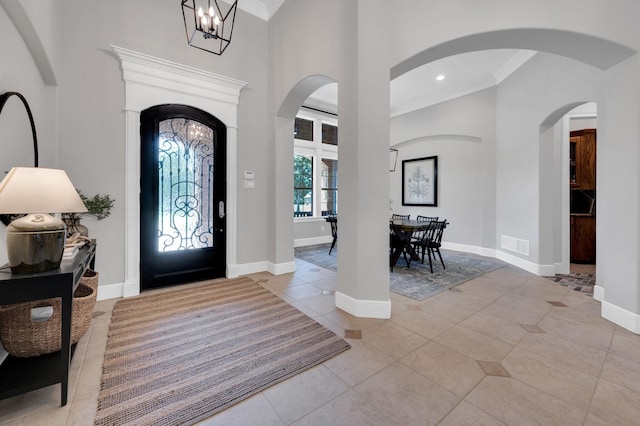 4340 Powers Branch Dr, Midlothian, TX 76065 - entrance foyer featuring crown molding, light tile patterned flooring, a chandelier, and a towering ceiling