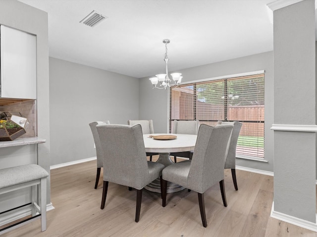 1507 Summertree Ct, Richardson, TX 75082 - dining room featuring light wood-type flooring, a chandelier, and baseboards