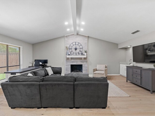 1507 Summertree Ct, Richardson, TX 75082 - living room featuring light wood-type flooring, a large fireplace, and baseboards