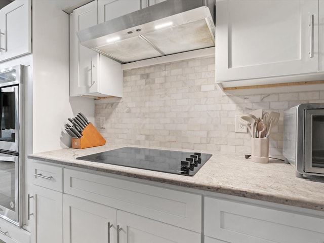 1507 Summertree Ct, Richardson, TX 75082 - kitchen featuring under cabinet range hood, black electric cooktop, decorative backsplash, and white cabinets