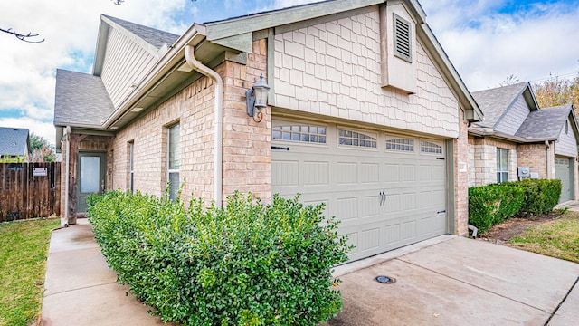 2231 Cobblestone Ct, Granbury, TX 76049 - view of side of home featuring a shingled roof, driveway, and a garage
