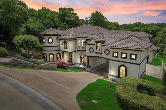 1608 Rivercrest Ct, Fort Worth, TX 76107 - mediterranean / spanish-style home with driveway, stucco siding, a tile roof, and a front lawn