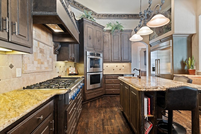 1608 Rivercrest Ct, Fort Worth, TX 76107 - kitchen with a sink, stainless steel appliances, custom range hood, and dark brown cabinets