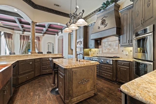 1608 Rivercrest Ct, Fort Worth, TX 76107 - kitchen featuring appliances with stainless steel finishes, arched walkways, coffered ceiling, dark brown cabinetry, and beamed ceiling