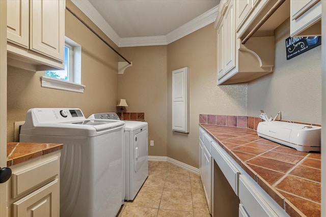 1608 Rivercrest Ct, Fort Worth, TX 76107 - washroom featuring washer and clothes dryer, cabinet space, ornamental molding, light tile patterned flooring, and baseboards